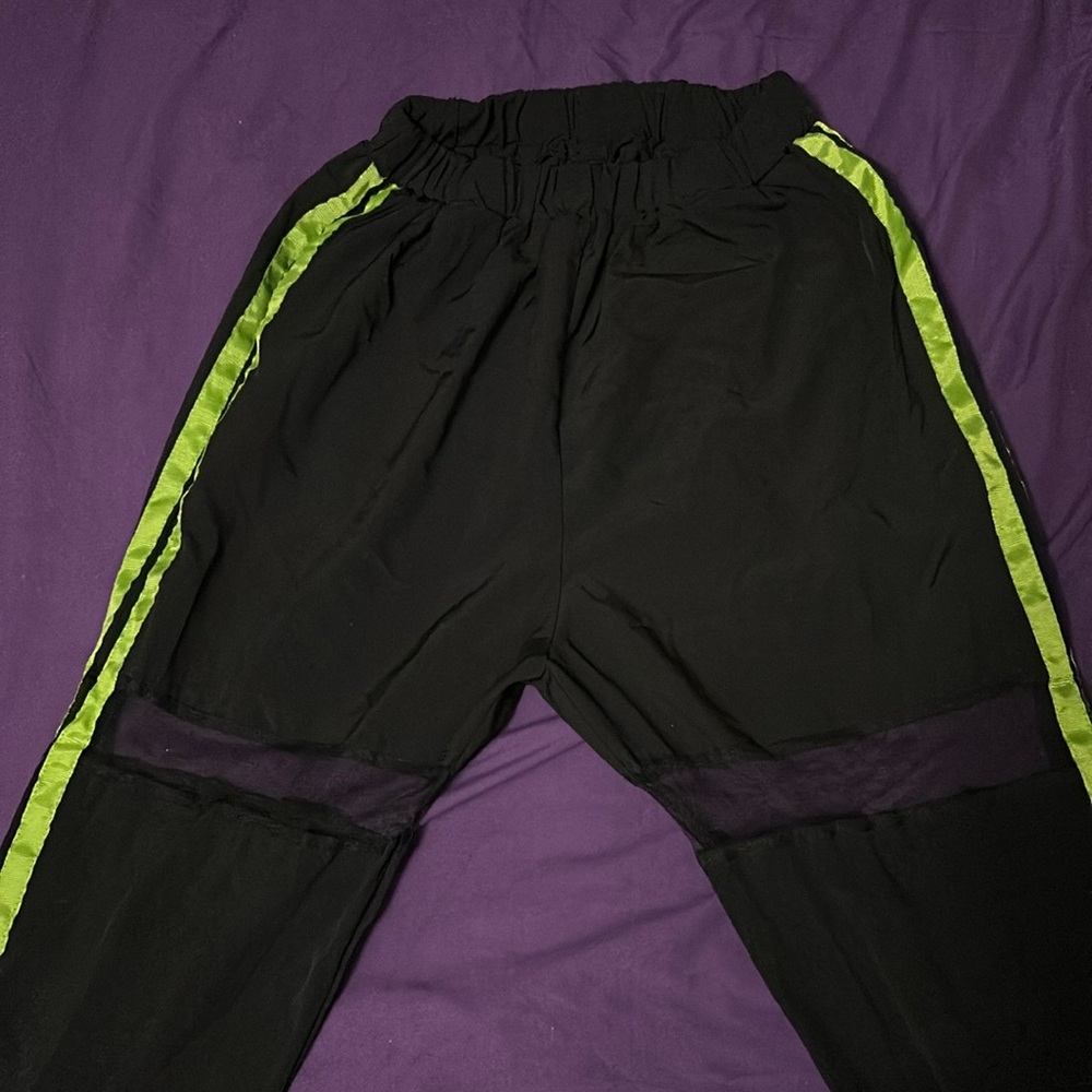 Black and lime green pants.